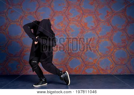 Young dancer dancing near the wall. Urban style