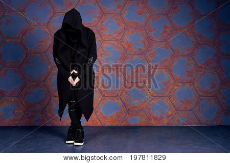 Young dancer standing near the wall. Urban style