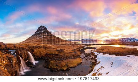 Spring Sunrise Over The Famous Kirkjufellsfoss Waterfall With Kirkjufell Mountain In The Background