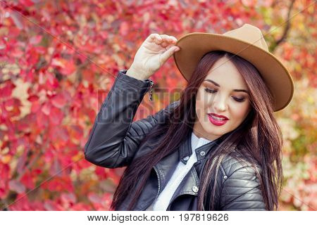 Young Beautiful Woman In A Hat And Jacket In Autumn Park. Warm Autumn. Autumn Portrait Of A Happy Gi