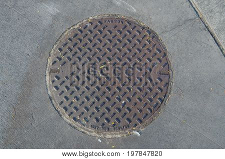Gold Coast Australia - July 12 2017: manhole cover bearing the acronym of the Gold Coast City Council.