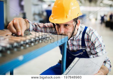 Supervisor doing quality control and pruduction check in metal factory