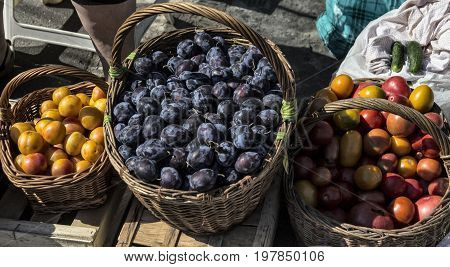 Domestic fruits and vegetables in wooden baskets market