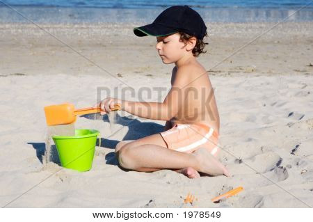 Boy Playing In The Beach