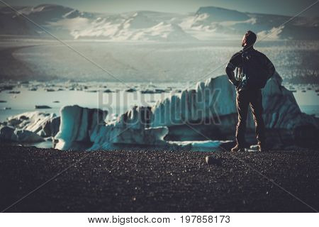 Man explorer lookig at Jokulsarlon lagoon, Iceland.