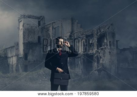 Businessman standing over apocalyptic background. Crisis, default, setback concept.