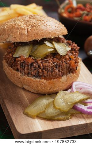 Ground beef burger sandwich with pickles and french fries