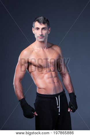 portrait of hand wrapping half nude boxer.