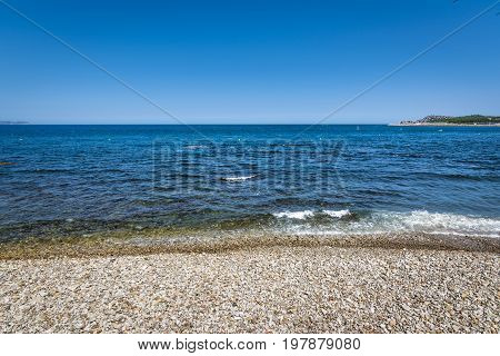 Rocky beach of Costa Brava in beautiful town of l'Escala, Spain.