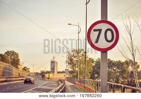 Prohibition road sign. Speed ​​limit to 70 km/h in shallow depth of field.