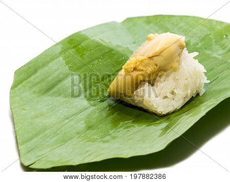 coconut custard with sticky rice. Put green banana leaves. On a white background (Isolated with clipping part). This is a dessert of Thailand. Sweet and delicious taste.