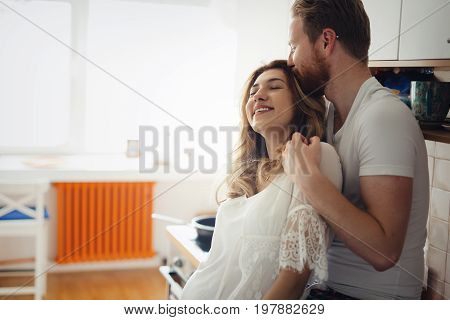 Romantic couple in love speding time together in kitchen
