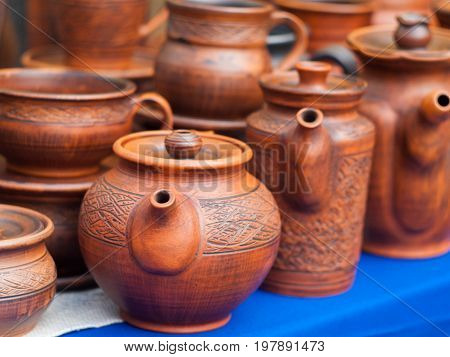 Ceramic teapots and mugs on the pottery fair. Ceramic tableware