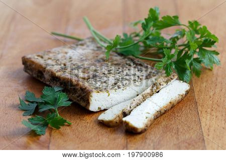 Block Of Marinated Tofu With Herbs, Two Tofu Slices And Fresh Parsley  On Wooden Chopping Board.
