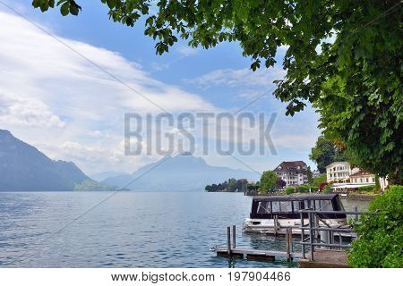 Vitznau Switzerland - June 14 2017: Beautiful view on the lake Luzern nearby city of Vitznau. Mountain Pilatus on background