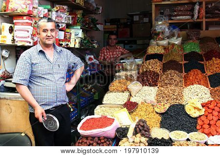 ALMATY, KAZAKHSTAN - MAY 30, 2014 - Green Bazaar. Vendor of dried fruits and nuts.