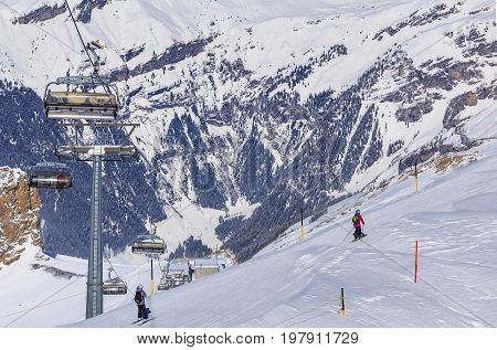 Mt. Titlis, Switzerland - 9 March, 2016: people skiing on Mt. Titlis. The Titlis is a mountain located on the border between the Swiss cantons of Obwalden and Bern, mainly accessed from the town of Engelberg on the northern side.