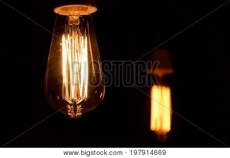 Bulb in the dark room with other one on the background