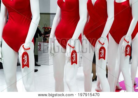 A Series Of Mannequins In Red Swimsuits.sale