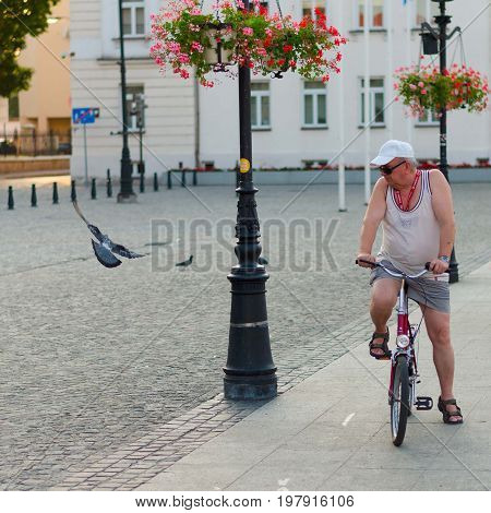 Plock Poland 4 August 2015 Editorial photo of man with bike who is watching pigeon Plock Poland