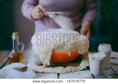 Close Up View Of Baker Kneading Dough. Homemade Bread. Hands Preparing Bread Dough On Wooden Table.