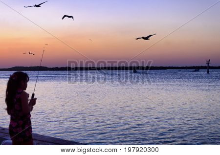 Sunset with girl on the waterfront in Rio Lagartos Mexico