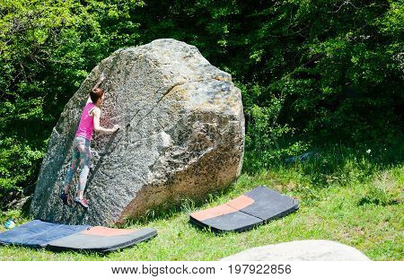 Climber Is Bouldering Outdoors.