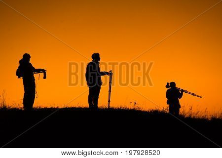 Silhouette of aphotographers top of mountain on sunset. At Doi-Monjong Chiangmai Thailand