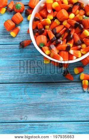 Halloween Candy Corns In Bowl On Blue Wooden Background