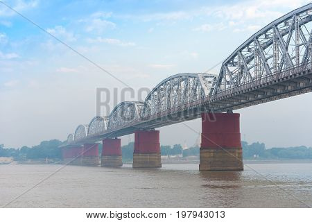 Steel Bridge Over The Irrawaddy River In Mandalay, Myanmar, Burma. Copy Space For Text.