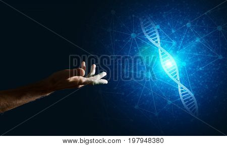 Close of man hand presenting DNA molecule research as concept. Mixed media