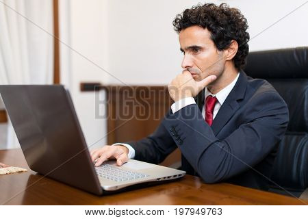 Businessman using a laptop in his office