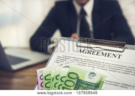 Agreement contract with money Euro currency given to a businessman - loan remuneration and bribery concepts