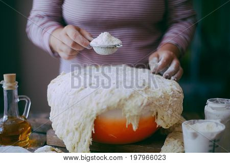 Close Up View Of Baker Kneading Dough. Homemade Bread. Hands Preparing Bread Dough On Wooden Table.