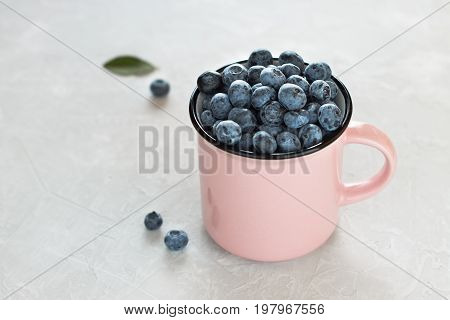 Fresh Blueberries In Pink Mug Or Cup On Light Gray Background.