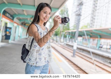 Woman taking photo in Hong Kong light rail station