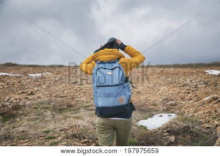 Hiker - girl walking up the steep hill.