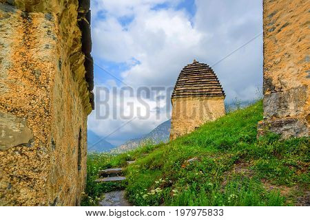 City of the dead or a necropolis near the village of Dargavs in Alania. Old cemetery with traditional crypts and tombs in the mountains