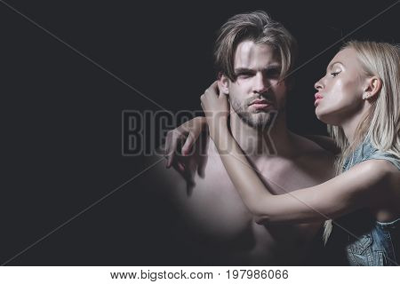 Couple in love of sexy man and woman. Man with muscular body with sexy girl. Love and romance.on black copy space