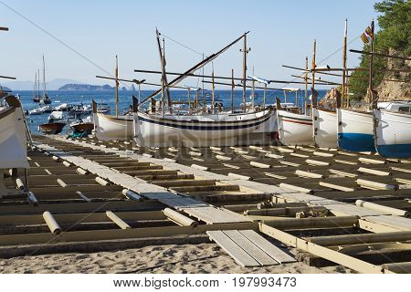 Traditional wooden boats in a dry dock in the Sa Riera beach at Catalonia Spain