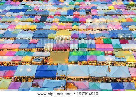 Train market secondhand market in Bangkok Thailand.photo of night market high view from building colorful tent retail shop and lighting.1 oct 2016 bangkok thailand