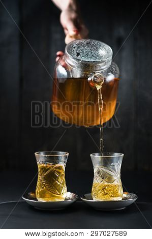 The Girl Pours Tea In An Armud.