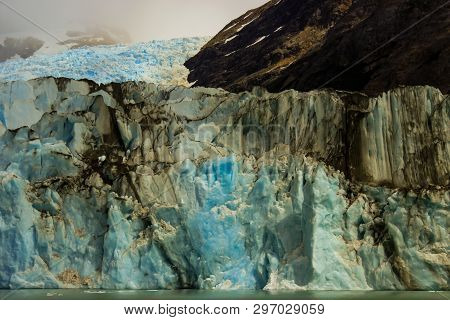 Huge Glacier Ice Wall. Ice In Patagonia Coming From The Andes Mountain Range. Glacier Of Calafate.