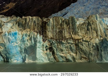 Huge Glacier Ice Wall. Ice In Patagonia Coming From The Andes Mountain Range. Glacier Of Calafate.