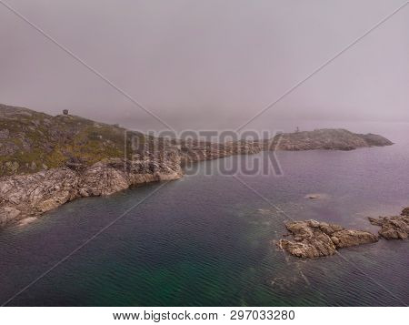 Lakes In Stone Rocky Mountains, Misty Foggy Day. Norway Summer Landscape. Norwegian National Tourist