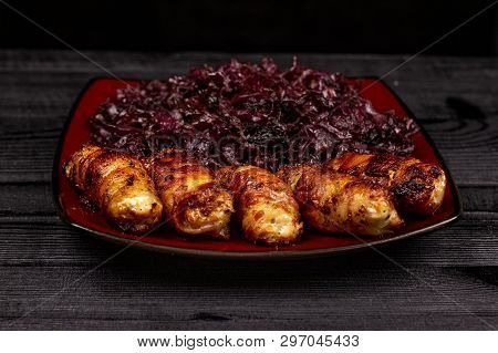 Fried Homemade Grilled Sausages Or Chevapchichi With Stewed Sauerkraut On A Wooden Rustic Background