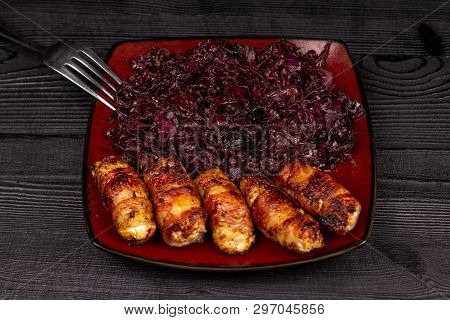 Fried Homemade Grilled Sausages Or Chevapchichi With Stewed Sauerkraut On A Wooden Rustic Background