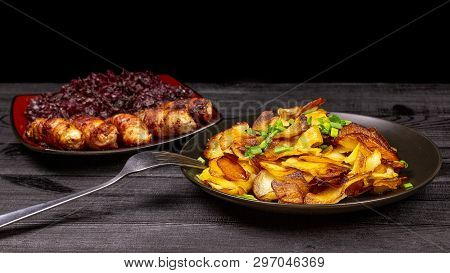 Fried Homemade Grilled Sausages Or Chevapchichi With Stewed Sauerkraut On A Wooden Rustic Background