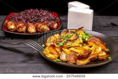 Fried Homemade Grilled Sausages Or Chevapchichi With Stewed Sauerkraut On A Wooden Rustic Background