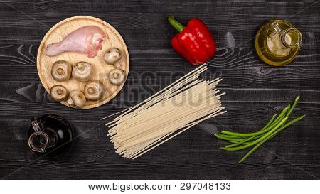 Fresh Ingredients For Cooking Home-made Fried Noodles On A Black Rustic Wooden Table. Top View